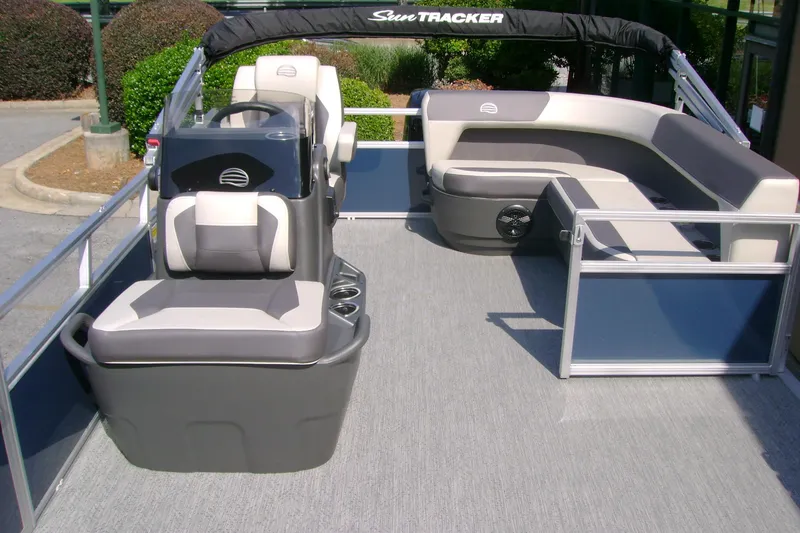 Slide: The Image of 2026 Sun Tracker Bass Buggy 16 XL Select pontoon boat interior with seating and helm. - 5