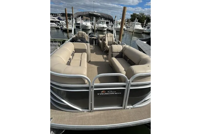 Slide: The Image of 2021 SUNTRACKER Tracker Marine boat dashboard with steering wheel and controls. - 5