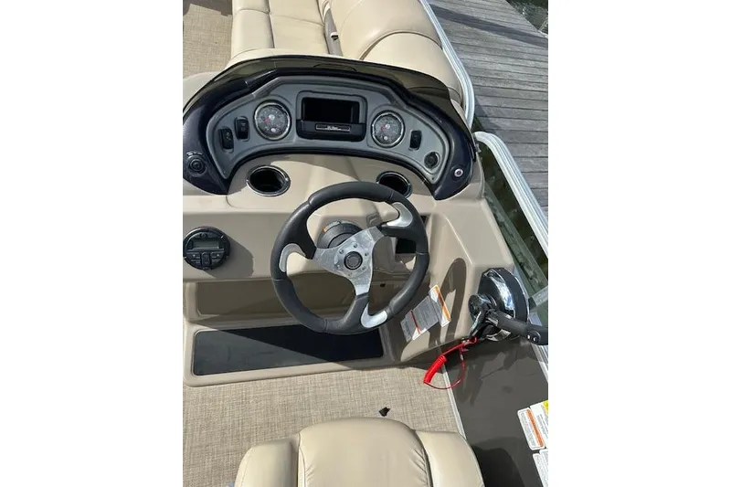Slide: The Image of 2021 SUNTRACKER Tracker Marine boat interior with beige seating and lake view. - 6
