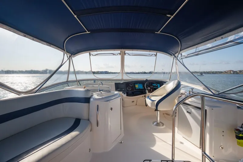 Slide: The Image of Interior view of 2010 Meridian 391 Sedan yacht helm with blue canopy. - 26