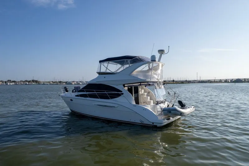 Slide: The Image of 2010 Meridian 391 Sedan yacht on calm water under clear blue sky. - 40
