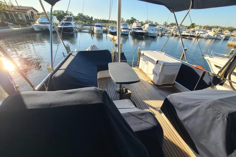 Slide: The Image of Grand Banks 46 Classic yacht deck, 2000 model, docked at marina with covered seating. - 14