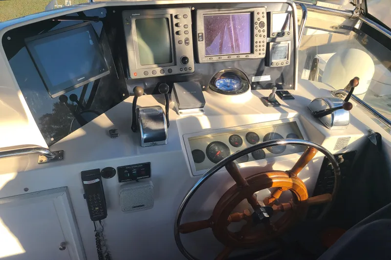 Slide: The Image of Helm of 2000 Grand Banks 46 Classic yacht with navigation equipment and wooden steering wheel. - 15