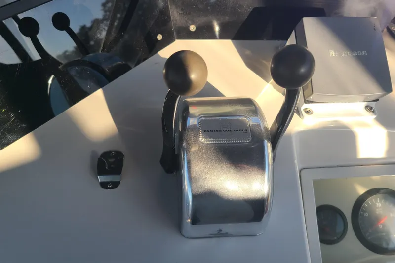 Slide: The Image of Control panel of 2000 Grand Banks 46 Classic yacht with throttle levers. - 16