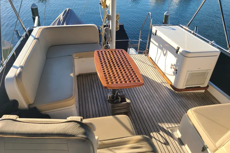 Slide: The Image of Grand Banks 46 Classic 2000 yacht deck with seating and wooden table. - 19