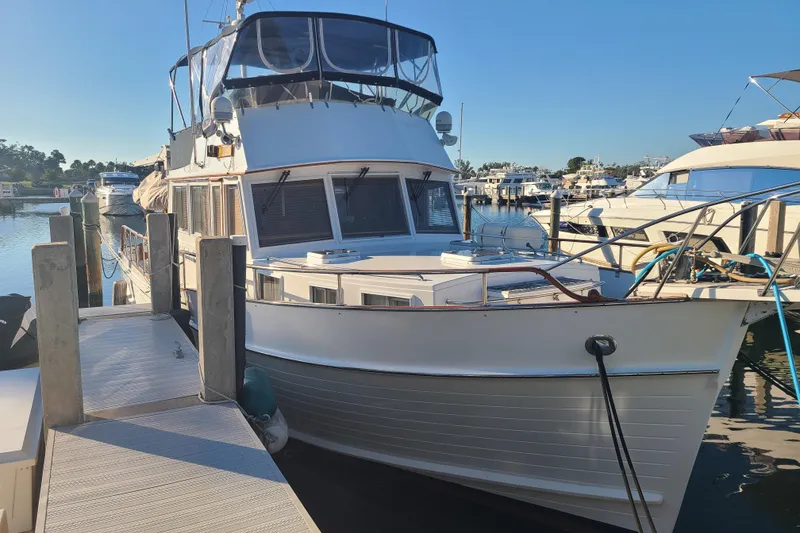 Slide: The Image of Grand Banks 46 Classic yacht, 2000 model, docked at a marina under clear skies. - 2