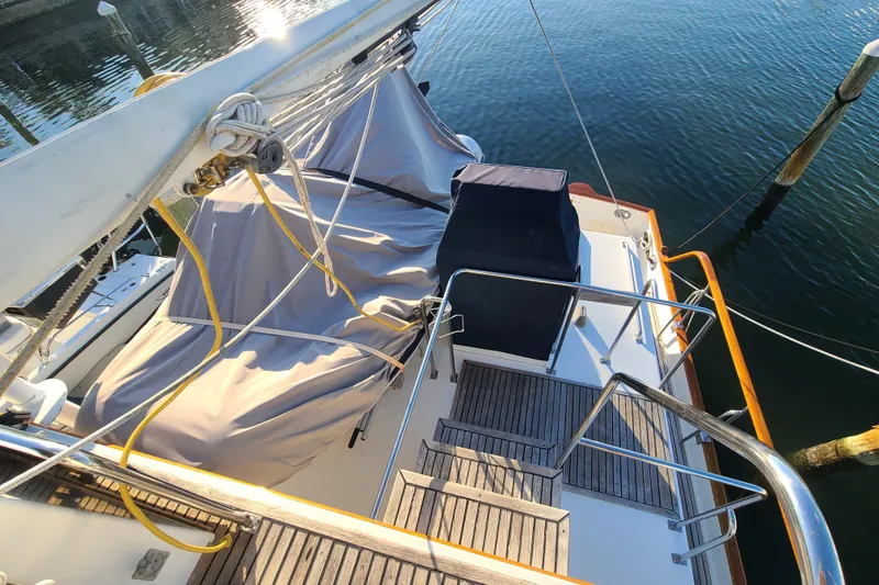 Slide: The Image of Grand Banks 46 Classic yacht deck, 2000 model, with covered seating and wooden flooring. - 23