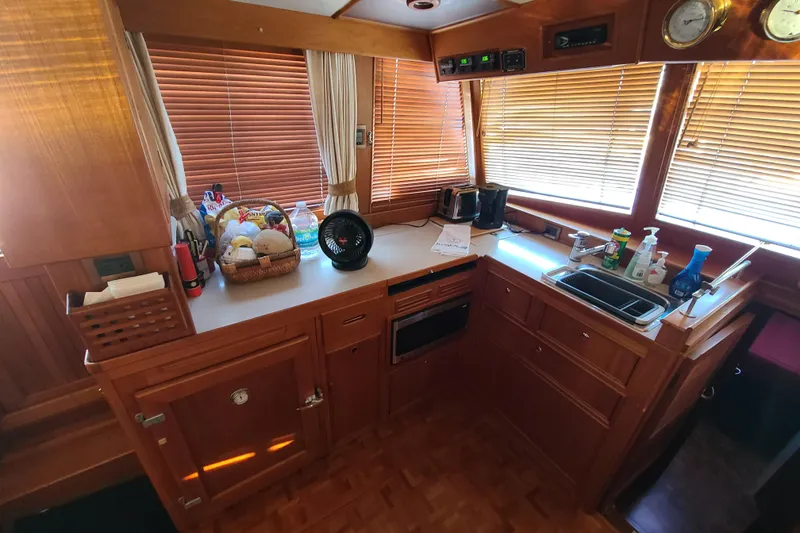 Slide: The Image of Galley of 2000 Grand Banks 46 Classic yacht with wooden cabinetry and modern appliances. - 27