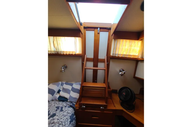 Slide: The Image of Cozy cabin interior of 2000 Grand Banks 46 Classic yacht with wooden ladder and bed. - 39