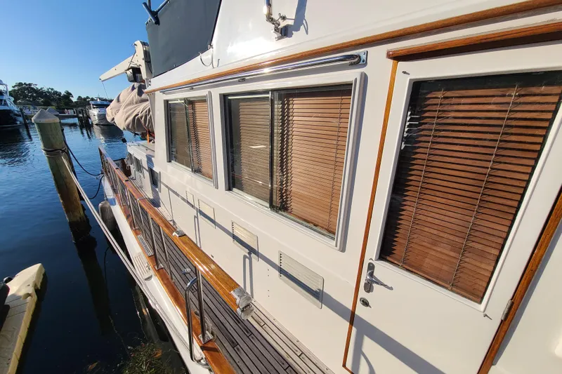 Slide: The Image of Grand Banks 46 Classic yacht, 2000 model, docked with wooden blinds and polished railings. - 4