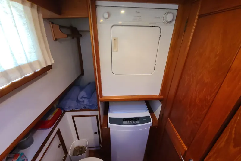Slide: The Image of Laundry area in 2000 Grand Banks 46 Classic yacht with washer and dryer. - 48