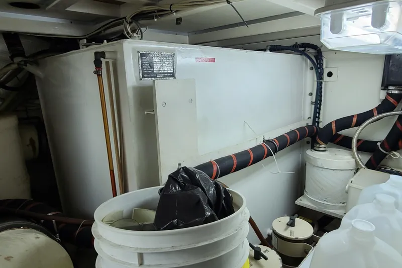 Slide: The Image of Engine room of 2000 Grand Banks 46 Classic yacht with equipment and storage containers. - 58