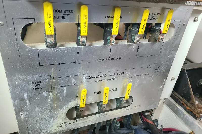 Slide: The Image of Fuel panel of a 2000 Grand Banks 46 Classic boat with labeled valves. - 65