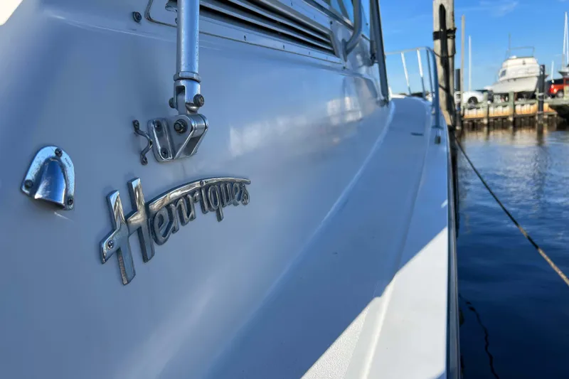 Slide: The Image of 2004 Henriques 35 Express boat docked, showcasing brand emblem and sleek design. - 104