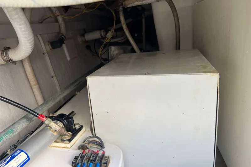 Slide: The Image of Engine compartment of 2004 Henriques 35 Express boat, showing mechanical components and wiring. - 11