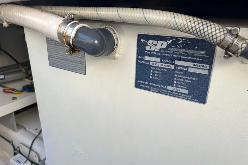 Slide: The Image of Fuel tank label on a 2004 Henriques 35 Express boat. - 13