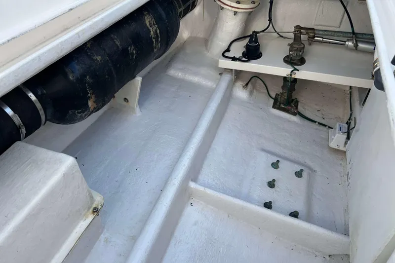 Slide: The Image of 2004 Henriques 35 Express boat interior, showcasing engine compartment and components. - 14