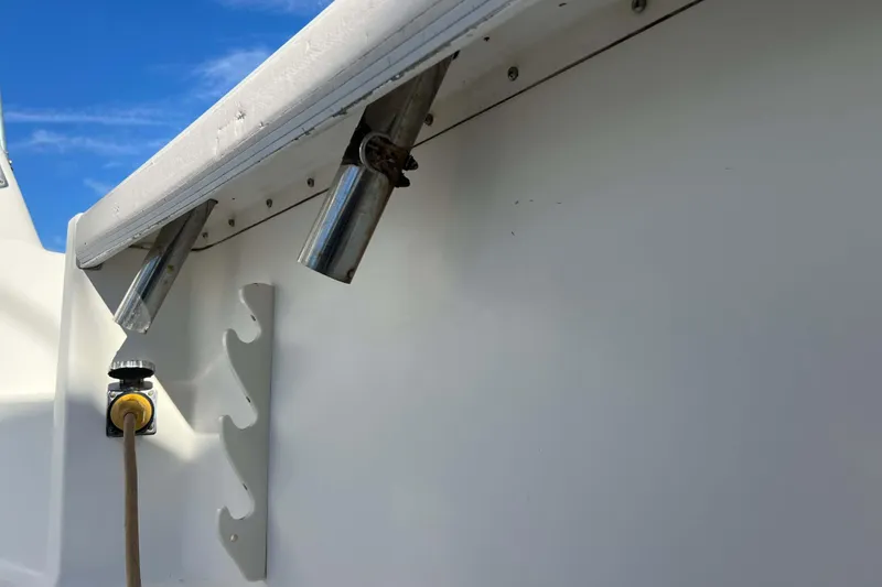 Slide: The Image of 2004 Henriques 35 Express boat interior with rod holders and power outlet. - 16