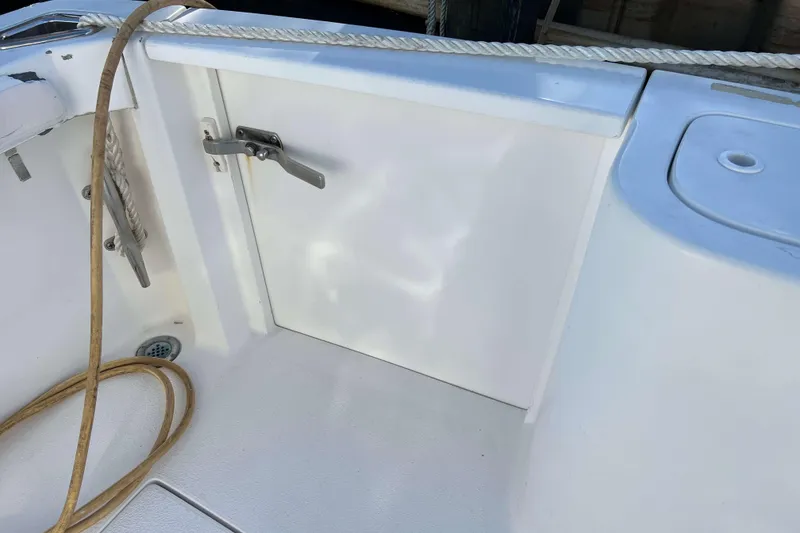 Slide: The Image of 2004 Henriques 35 Express boat deck with rope and storage compartment. - 17