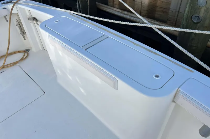 Slide: The Image of 2004 Henriques 35 Express boat deck with storage compartments and rope. - 18