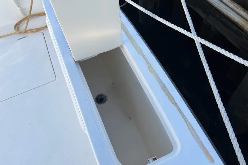 Slide: The Image of Open storage compartment on 2004 Henriques 35 Express boat deck. - 19