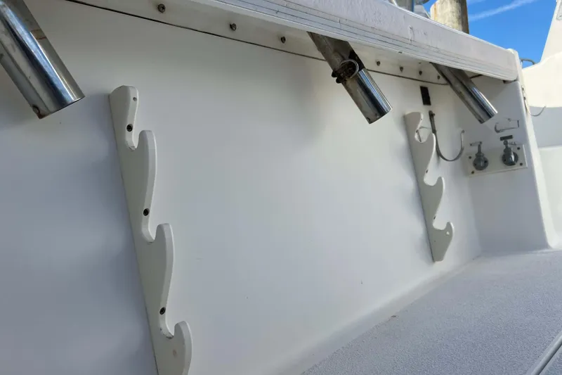 Slide: The Image of 2004 Henriques 35 Express boat interior with rod holders and utility fixtures. - 20