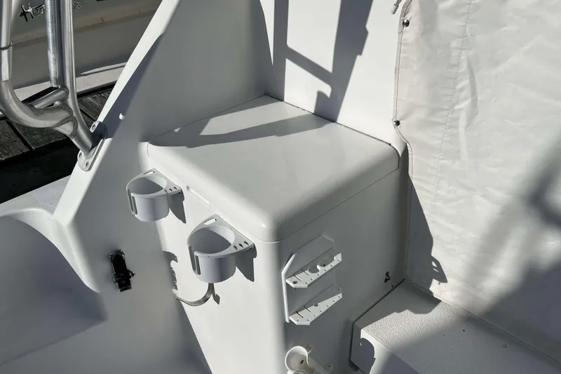 Slide: The Image of 2004 Henriques 35 Express boat interior with storage and cup holders. - 22