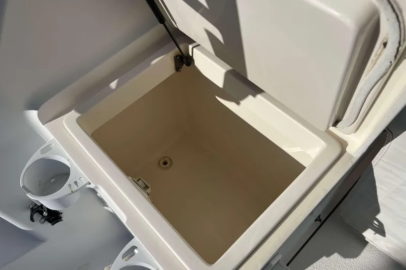 Slide: The Image of Open storage compartment on 2004 Henriques 35 Express boat, with cup holders nearby. - 23