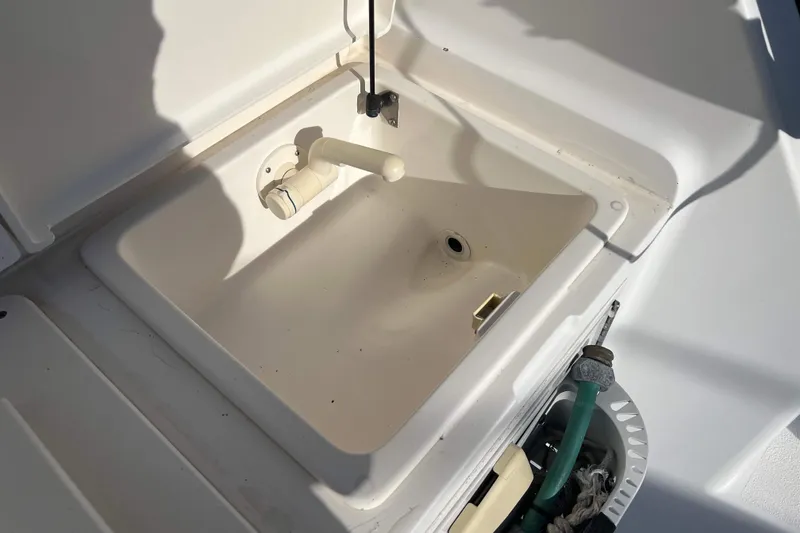 Slide: The Image of 2004 Henriques 35 Express boat sink with faucet and hose attachment. - 26