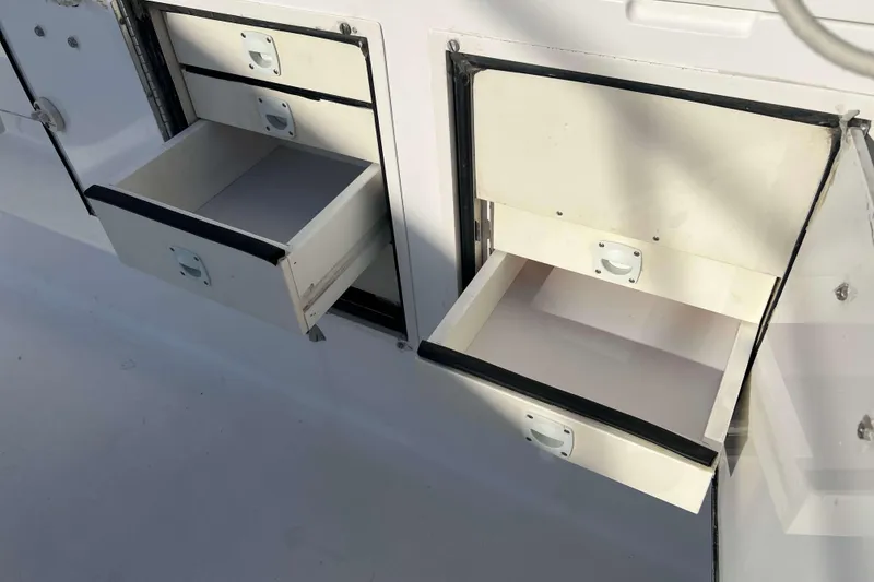 Slide: The Image of Open storage drawers on a 2004 Henriques 35 Express boat. - 28