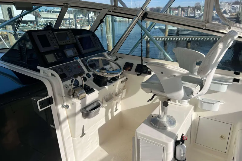 Slide: The Image of 2004 Henriques 35 Express boat helm with controls and captain's chair. - 30