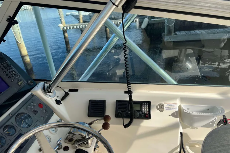 Slide: The Image of 2004 Henriques 35 Express boat cockpit with steering wheel and navigation equipment. - 34