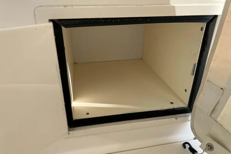 Slide: The Image of Open storage compartment on a 2004 Henriques 35 Express boat. - 38