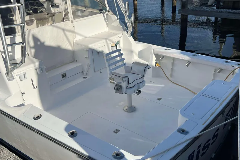 Slide: The Image of 2004 Henriques 35 Express boat cockpit with fishing chair and clean deck. - 4