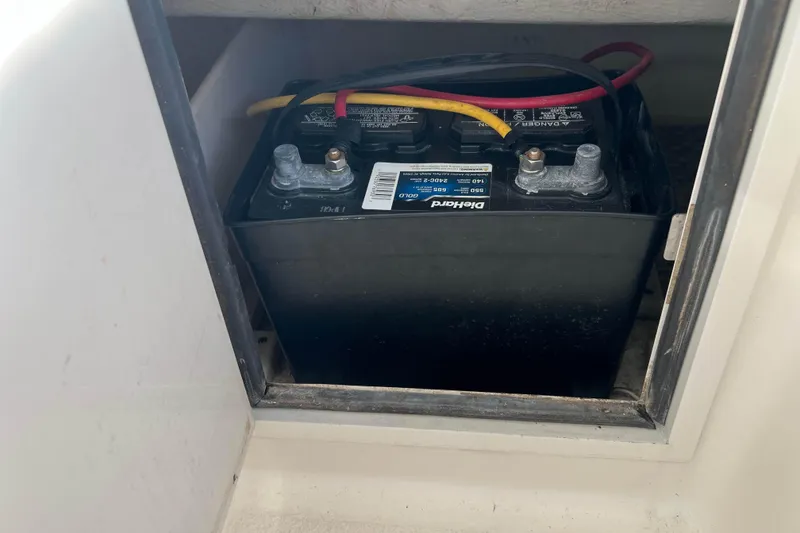 Slide: The Image of Battery compartment of a 2004 Henriques 35 Express boat, featuring a DieHard battery. - 40