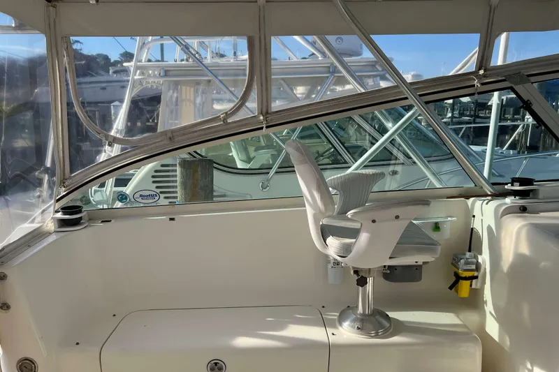 Slide: The Image of 2004 Henriques 35 Express boat interior with captain's chair and clear windows. - 43
