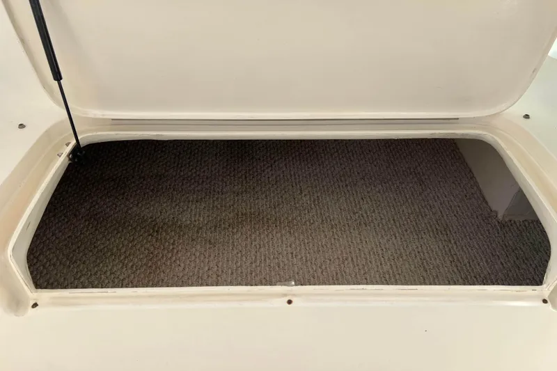 Slide: The Image of Storage compartment of 2004 Henriques 35 Express boat with carpeted interior. - 44