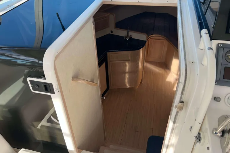 Slide: The Image of 2004 Henriques 35 Express cabin interior with kitchenette and seating area. - 47