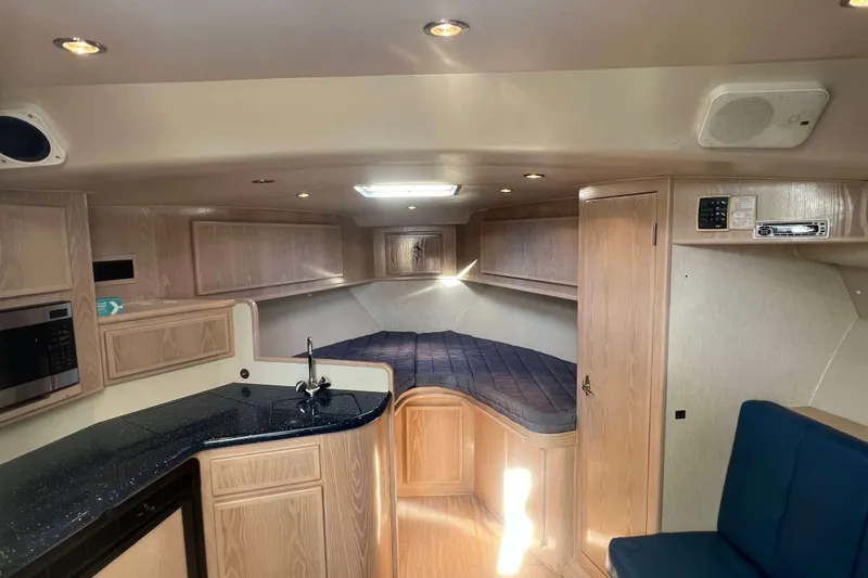 Slide: The Image of Interior of 2004 Henriques 35 Express boat with kitchenette and sleeping area. - 48