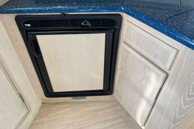 Slide: The Image of 2004 Henriques 35 Express interior with compact refrigerator and wooden cabinetry. - 54