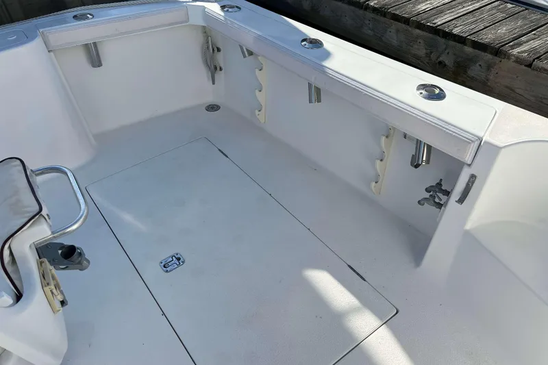 Slide: The Image of 2004 Henriques 35 Express boat deck with rod holders and storage compartments. - 6