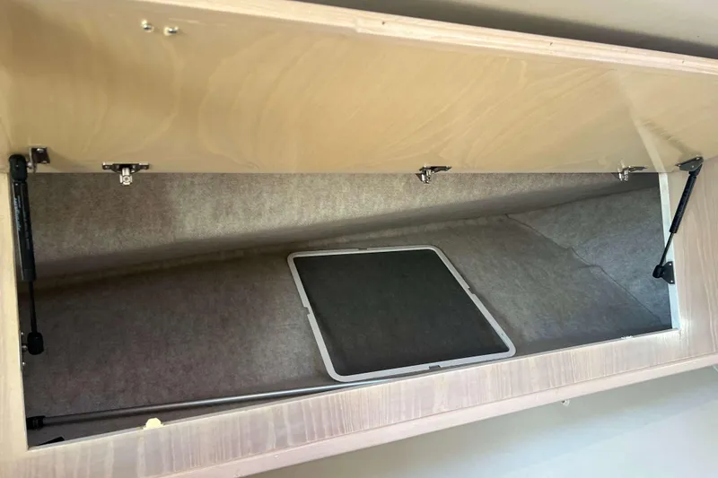 Slide: The Image of Open storage compartment in 2004 Henriques 35 Express boat interior. - 60