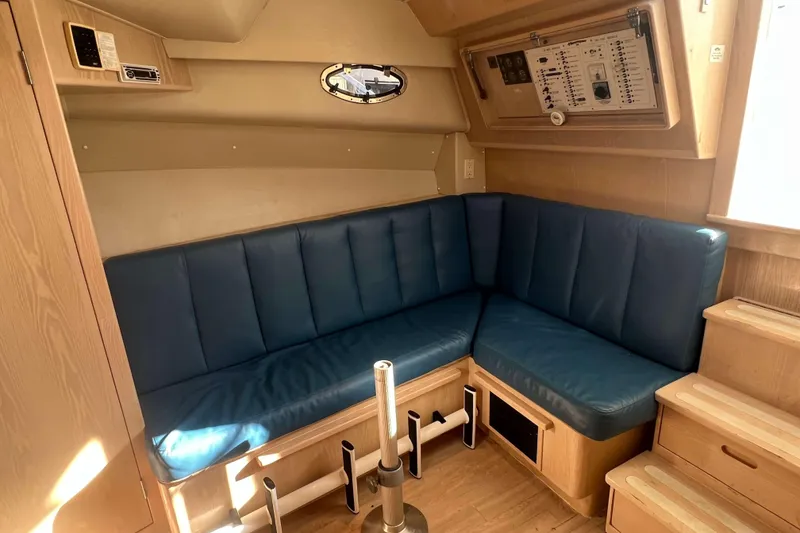 Slide: The Image of 2004 Henriques 35 Express cabin with blue seating and wooden interior. - 66