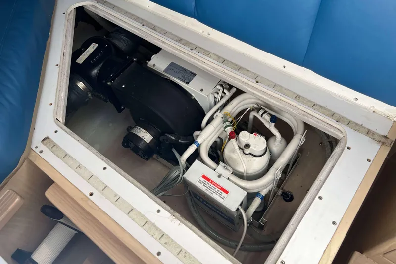 Slide: The Image of Engine compartment of a 2004 Henriques 35 Express boat, showcasing mechanical components. - 69