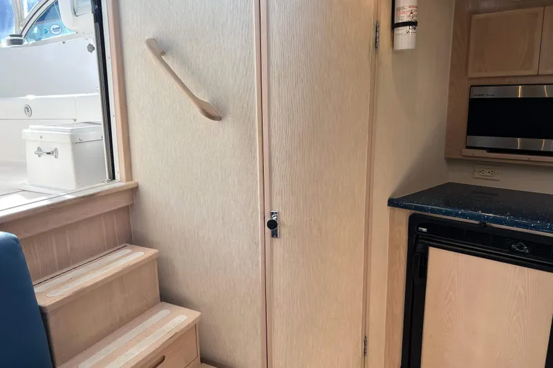 Slide: The Image of Interior of 2004 Henriques 35 Express boat with stairs, kitchenette, and microwave. - 71