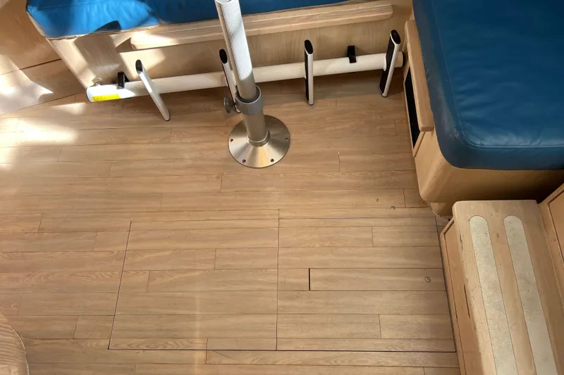 Slide: The Image of Interior of 2004 Henriques 35 Express boat with wooden flooring and blue seating. - 78