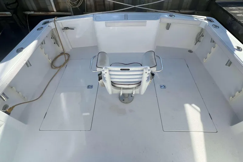 Slide: The Image of 2004 Henriques 35 Express boat deck with central chair and fishing rod holders. - 81