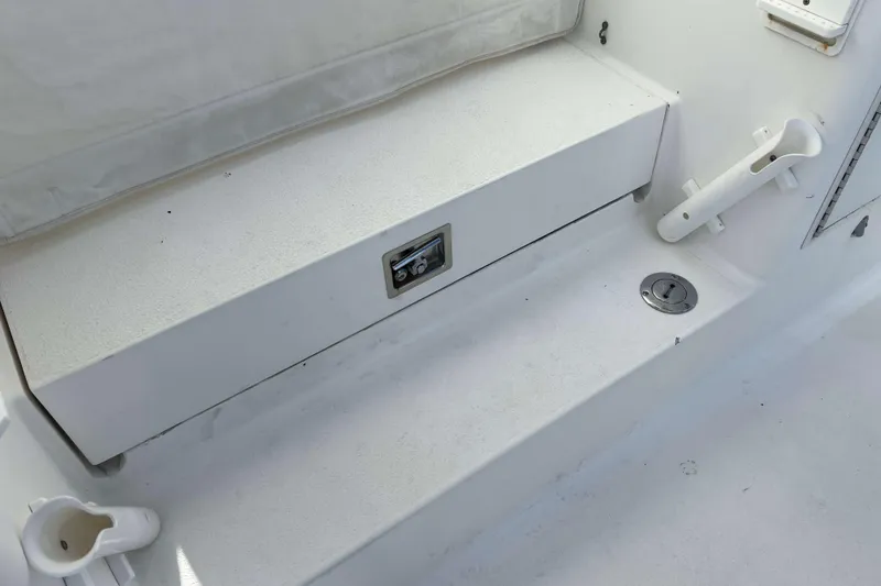 Slide: The Image of 2004 Henriques 35 Express boat deck with rod holders and storage compartment. - 82