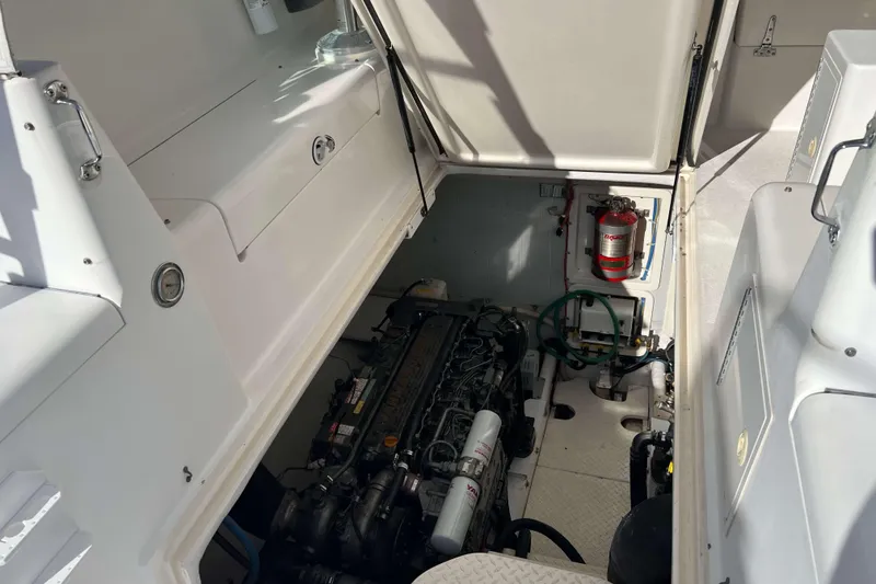 Slide: The Image of Engine compartment of a 2004 Henriques 35 Express boat, featuring visible machinery and equipment. - 83