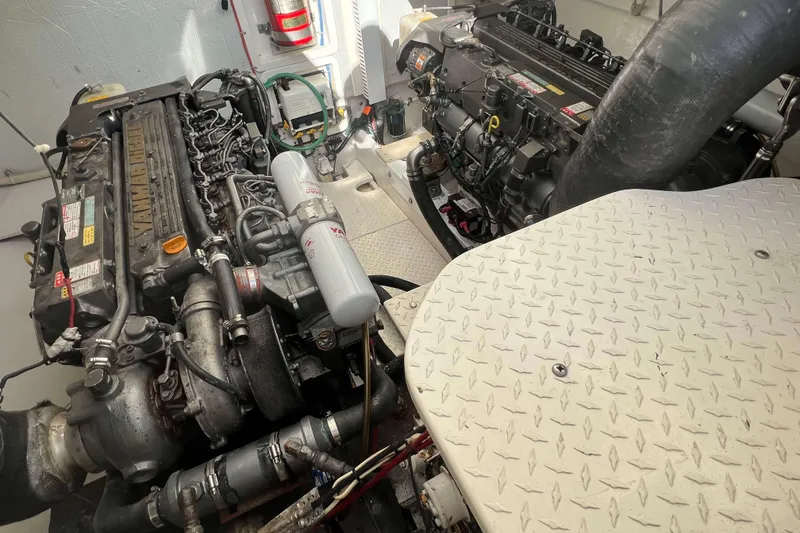 Slide: The Image of Engine room of a 2004 Henriques 35 Express boat with visible machinery. - 84